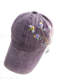 Hand Embroidered Floral And Bee Denim Baseball Cap Material: This denim cap is embroidered by cotton thread. You can adjust circumference of the hat. - Cap circumference : 54-60 cm - Cap depth: 12 cm - Cap brim length: 7 cm -Color: Purple I love embroidery and I think this is a gift of thought for this life. If you like, own it or give this meaningful gift to relatives and friends. NOTE: The color can slightly be different due to monitor setting. Please make sure you do not mind this when purchase. **Have a look at my other products here: https://www.etsy.com/shop/AnhsEmFash **My Instagram : https://www.instagram.com/anhsemfash Thank you so much for shopping with me! _Anh's EmFash_ Cotton Hat With Embroidered Patch And Curved Brim, Cotton Brimmed Baseball Cap, One Size Fits Most Brimmed Cotton Baseball Cap, Embroidered Cotton Hat With Curved Brim, Adjustable Cotton Hat With Embroidered Patch, Casual Embroidered Brimmed Hats, Purple Cotton Baseball Cap With Curved Brim, Purple Cotton Baseball Cap, Adjustable Cotton Trucker Hat With Embroidered Patch