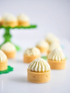 small desserts with white frosting sitting on a table