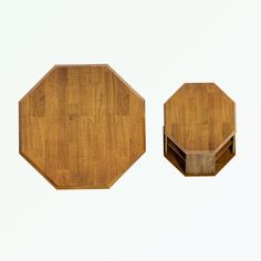 two octagonal wooden tables sitting next to each other on a white surface with no one around them