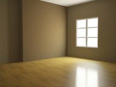 an empty room with light coming in from the window and wood flooring on the far wall