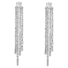 The 4-Drop Diamond Chandelier Earrings are adorned with a mesmerizing combination of Baguette and Round Cut diamonds. The Baguette Cut diamonds add a sleek and elongated shape to the design, creating a modern and sophisticated look. These rectangular-shaped diamonds are meticulously arranged to enhance the overall elegance of the earrings. Complementing the Baguette Cut diamonds are the Round Cut diamonds, which bring a timeless and brilliant sparkle to the piece. The round-shaped diamonds are c Chandelier Long, Modern Hoop Earrings, Diamond Chandelier Earrings, Diamond Chandelier, Round Diamond Earrings, Large Stud Earrings, White Gold Studs, Long Drop Earrings, Diamond Hoop Earrings