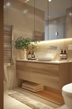 a bathroom with a toilet, sink and mirror in it's center wall area