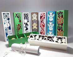 several different colored boxes with designs on them and a white ribbon tied around the box