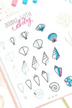 an open notebook with doodles and sea shells on it