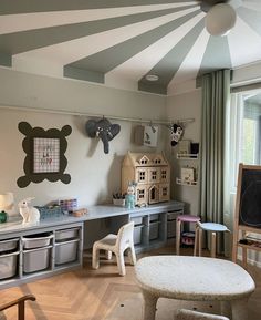 a child's playroom with toys and decor on the walls, along with toy storage bins