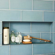 a shelf in a bathroom filled with personal care items