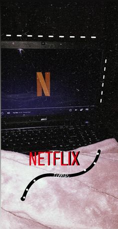 a black laptop computer sitting on top of a white bed next to a red netflix logo