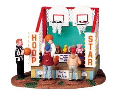 two small figurines are standing in front of a basketball hoop