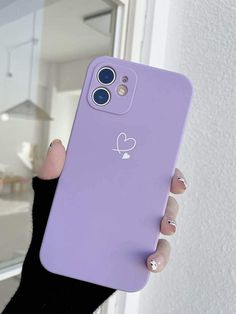 a person holding up a purple phone case