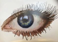 an eye with long eyelashes is shown in this artistic photo, it appears to be made out of paper