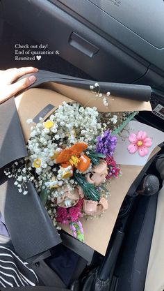 flowers are placed on top of a piece of paper in the back seat of a car