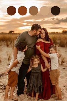 a family posing for a photo on the beach