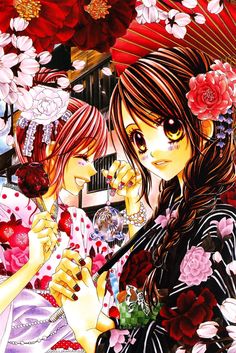 two women standing next to each other under an umbrella with flowers on it and one holding a cell phone