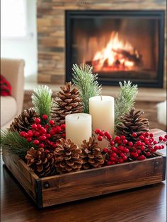 a wooden tray filled with pine cones and candles