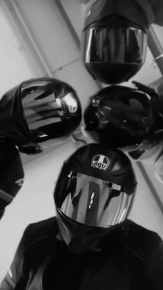 black and white photograph of motorcycle helmets on display