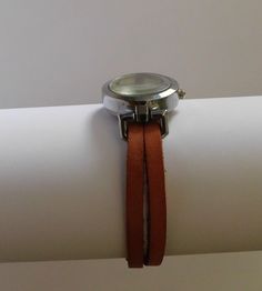 This is a simple women watch with a leather flat cord strap. The style is retro minimalist with a simple distress look. The face of the watch is made in silvered finish alloy, free of nickel and lead, round shape 1 inch diameter. The strap comes in 6 sizes: XS for a 6.00 inches wrist S for a 6.25 inches wrist M for a 6.50 inches wrist L for a 6.75 inches wrist XL for a 7.00 inches wrist XXL for a 7.25 inches wrist If you need another size, please send me a message. The clasp is magnetic and is m Trendy Everyday Watches With Leather Strap, Minimalist Everyday Watch With Adjustable Fit, Adjustable Minimalist Watches For Everyday Use, Minimalist Adjustable Watches For Everyday Use, Minimalist Adjustable Everyday Watches, Retro Minimalist, Round Watch, Minimalist Watch, Watch For Women