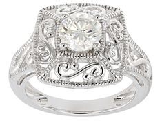 a white diamond ring with filigrees on the sides