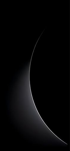 an abstract black and white photo with curved lines in the dark space that appears to be half - lit