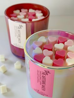 two tins filled with marshmallows sitting next to each other