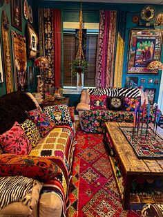 a living room filled with lots of colorful furniture and rugs on top of each other