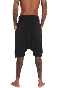 Breathable, super lightweight, water resistant active fabric meets tailored structure in these black techwear shorts. The Dublin Mens Drop Crotch Shorts have a streetwear aesthetic but function as a multi purpose garment. Comfortable enough to lounge in and suitable to swim in; the perfect shorts for travelers and spontaneous souls. FEATURES: Harem style: low dropped crotch Long length, hits just below the knee Four pockets, two with zippers, one of which is hidden Belt loops Diagonal zip fly Ma Techwear Shorts, Black Techwear, Streetwear Shop, Streetwear Aesthetic, Long Length, Dublin, Lounge Wear, Water Resistant, Lounge