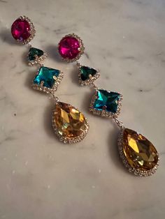 This lightweight oversized crystal drop earring in hot, pink emerald green turquoise blue and golden teardrop is sure to catch the eye ! Luxury Crystal Gemstone Earrings, Glam Earrings, Pink Emerald, Magnolia Pearl, Crystal Drop Earrings, Crystal Drop, Green Turquoise, Turquoise Blue, Emerald Green