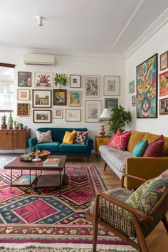 Mismatched furniture, vibrant gallery walls, and patterned rugs bring personality to this eclectic living room 🎭.  #EclecticStyle #LivingRoomDecor #BoldDesign #UniqueSpaces Living Room With Mismatched Furniture, Mismatched Gallery Wall Living Room, Mexico City Home Decor, Mismatched Home Decor, Eclectic House Decor, Bright Rug Living Room, Mismatched Furniture Living Room, Boho Eclectic Living Room Ideas, Mismatched Couches Living Room