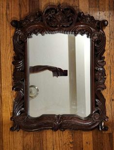 Gorgeous vintage Baroque-style wooden mirror featuring intricate carved details. The mirror measures 28 inches tall by 20 inches wide and is made of solid wood, giving it a high-quality, durable feel. It's a beautifully crafted piece that will bring an elegant and dramatic touch to any room. This stunning mirror is in excellent condition and weighs, reflecting its solid construction and craftsmanship. Perfect for adding a vintage flair to your home decor! Desired House, Fancy Mirror, Fancy Mirrors, Baroque Decor, Brown Mirror, Wooden Mirror, Baroque Style, Mirror Frame, Vintage Mirror