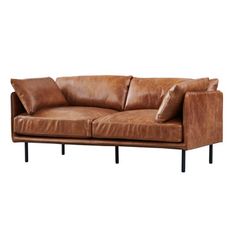 a brown leather couch with two pillows on it's back and one arm extended