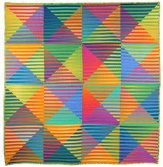 a multicolored quilt with different shapes and sizes