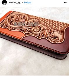 an orange and brown wallet sitting on top of a table