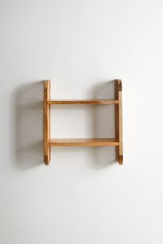 a wooden shelf mounted to the wall