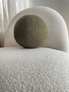 a ball sitting on top of a white chair