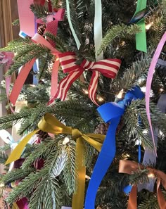 the christmas tree is decorated with ribbons and bows for holiday decor or as an ornament