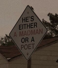 there is a sign that says he's either a madman or a poet