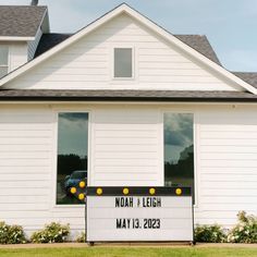 a sign in front of a white house that says noah and leigh may 13, 2013