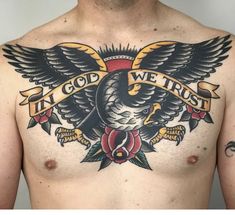 a man's chest with an eagle and rose tattoo design on his chest, which reads in god we trust