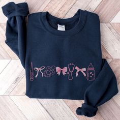 a black sweatshirt with pink writing on it