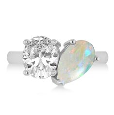 an oval white opal and diamond engagement ring set in 18k white gold with two claw prongs