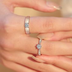 two women's hands with wedding rings on their fingers, one holding the other