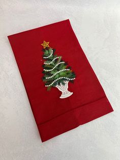 a red napkin with a christmas tree on it