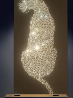 a large lighted piece of art in the shape of a cat