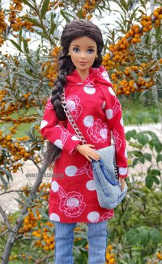 a doll is standing in front of a tree