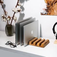 an apple computer sitting on top of a desk next to headphones