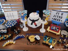 a table topped with lots of cupcakes and cake decorating items on top of a wooden table