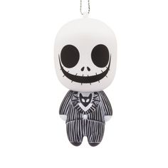 a keychain with a skeleton wearing a striped suit and bow tie on it