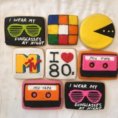 decorated cookies are arranged in the shape of music cassettes, sunglasses, and tape