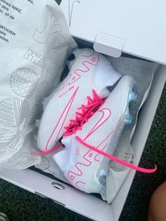 a white shoe with pink laces in a box