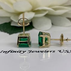 "These earrings are radiant cut lab created green emerald studs, 14k yellow gold #6228 -Approximate total carat weight: 3.50ctw diamond equivalent -Stone Size: approx. 1.75ct each diamond equivalent -Gem Type: emerald -Stone Shape: radiant cut 7x7mm each -Stone Clarity: VS2 -Stone Color: green -Moh's Scale: 8.5 Hardness -Metal Type and Purity: 14k yellow gold -Setting: 4 prong basketsetting -Backing: screw back (earring backs are subject to change due to availability) -Country of Manufacturing: Classic Green Diamond Cut Earrings, Green Emerald Earrings With Prong Setting, Green Prong Setting Earrings In Fine Jewelry Style, Emerald Cut Green Earrings, Gold Emerald Cut Emerald Earrings, Gold Emerald-cut Emerald Earrings, Green Earrings For Anniversary, Gold Emerald-cut May Birthstone Earrings, Gold Emerald-cut Earrings For May Birthstone