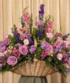 a basket filled with lots of purple flowers